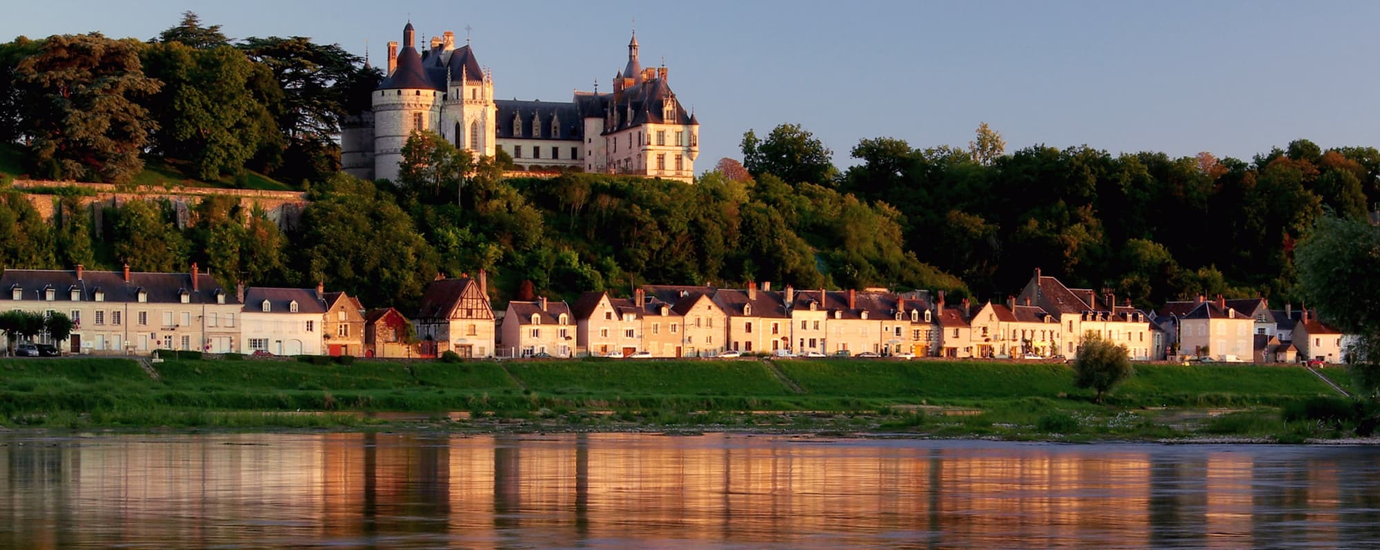 Mousserande i världen: Vinodlingar på banken av floden Loire i kvällsljus.